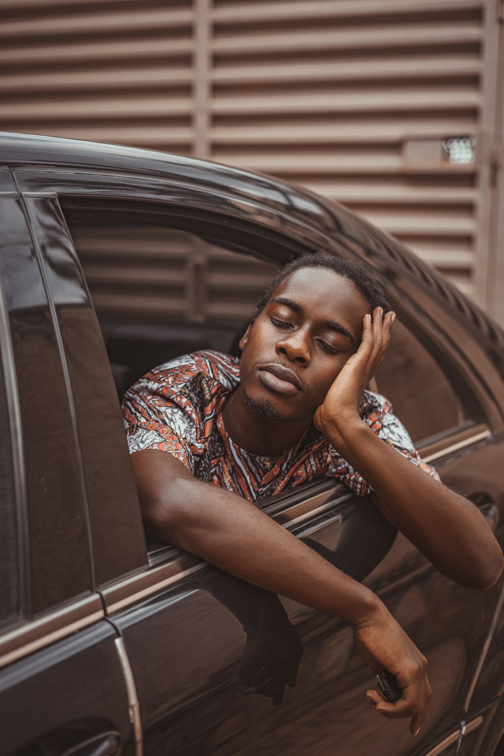 a man leaning his head out of a car window