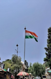 A national flag proudly displayed on a tall flagpole.