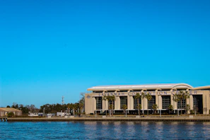 A wide shot of the Miami convention center exterior with PBExpo 2026 banners fluttering in the breeze.