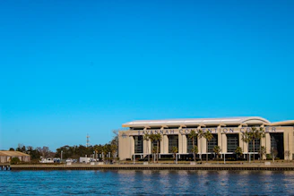 A wide shot of the Miami convention center exterior with PBExpo 2026 banners fluttering in the breeze.