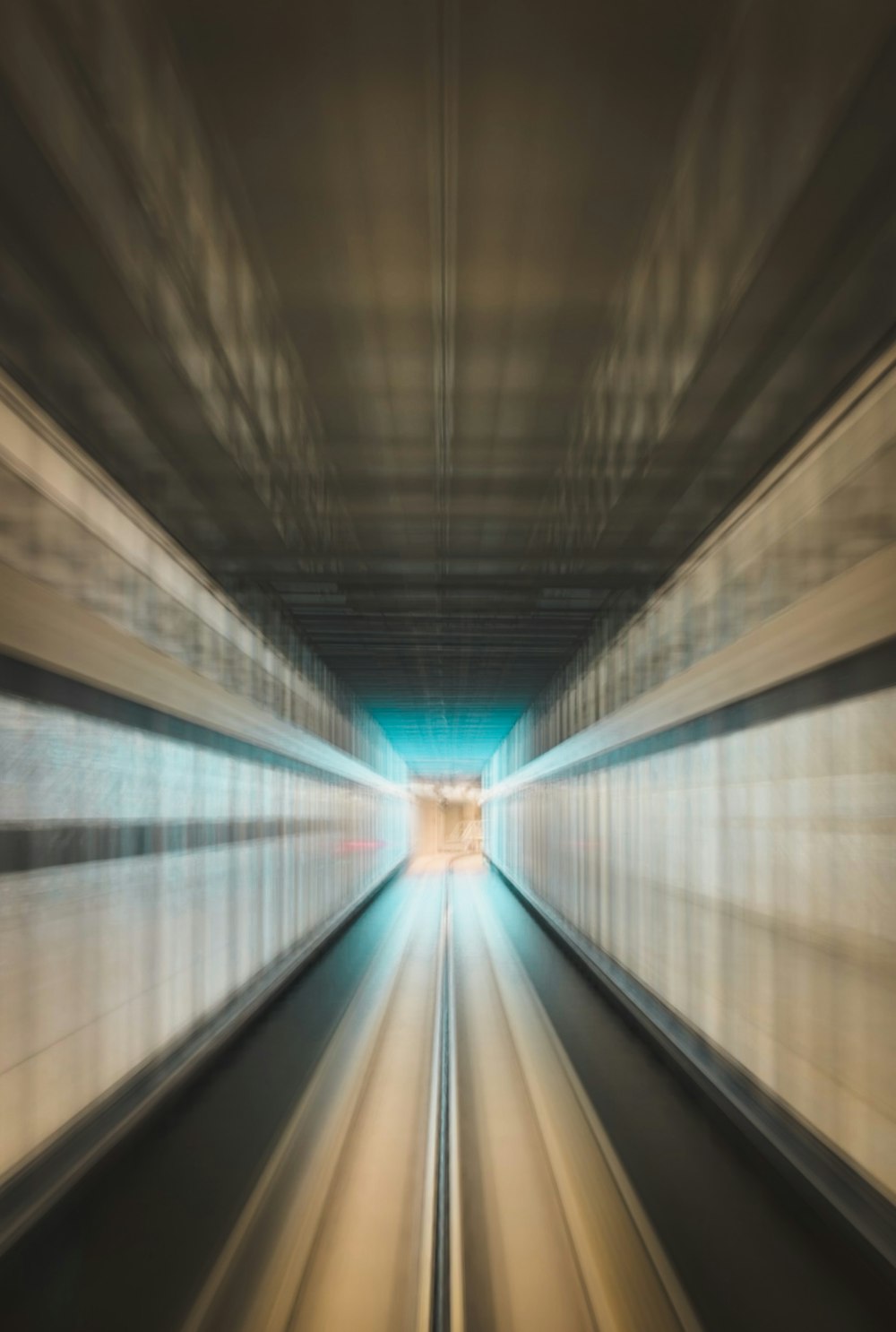 a blurry photo of a train going through a tunnel