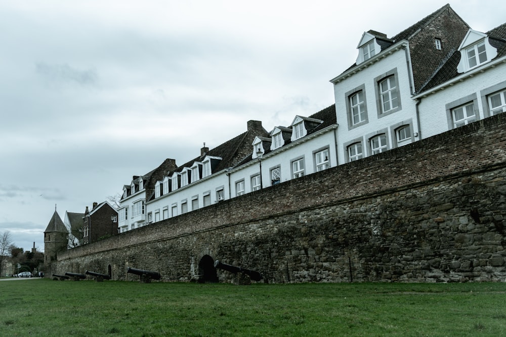 a large stone wall with a bunch of windows on top of it