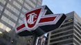 a close up of a street sign with a building in the background