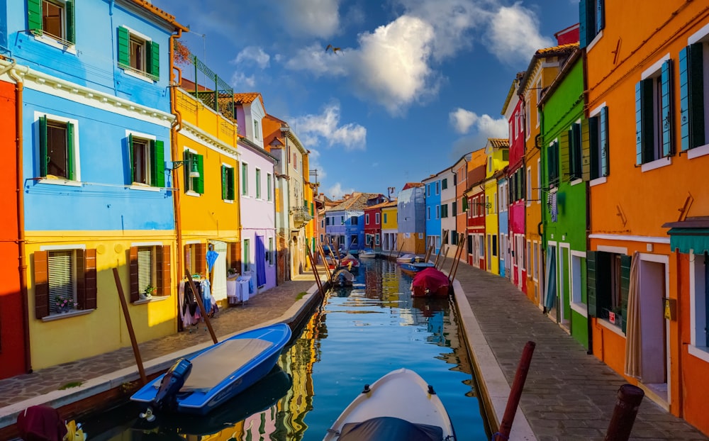 a row of colorful buildings next to a body of water