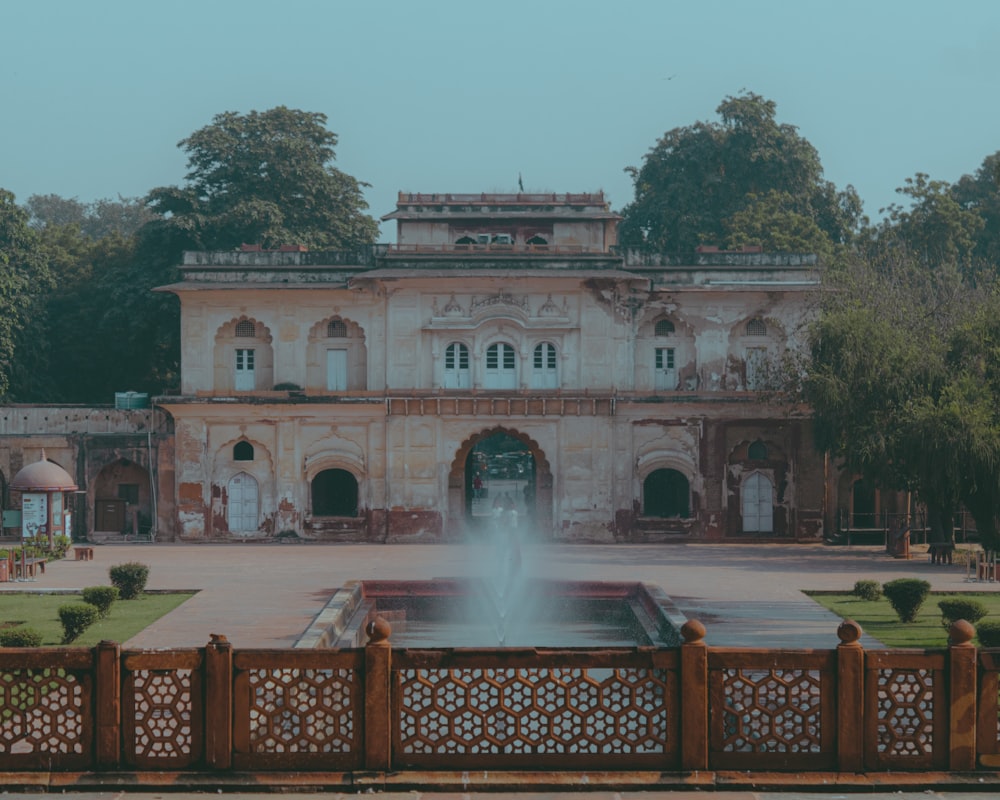 a large building with a fountain in front of it