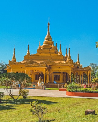 a large yellow building with many spires on top of it