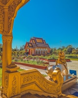 a golden statue in front of a building