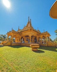 a large yellow building sitting on top of a lush green field