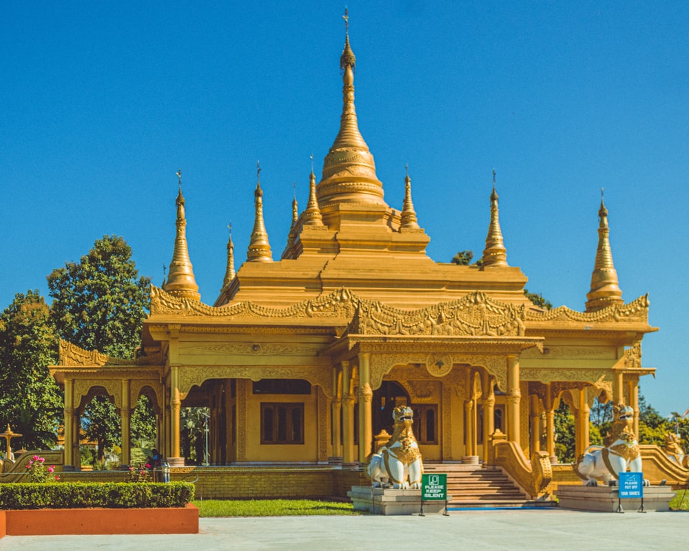 a large yellow building with many spires on top of it