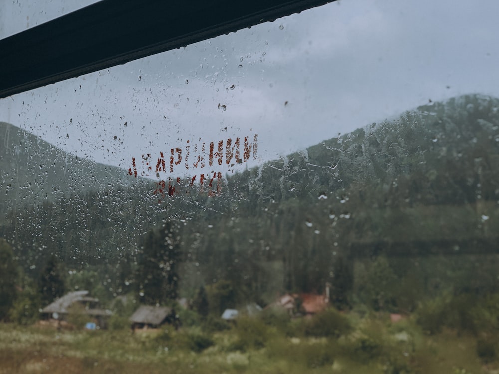 a window with a view of a mountain and trees