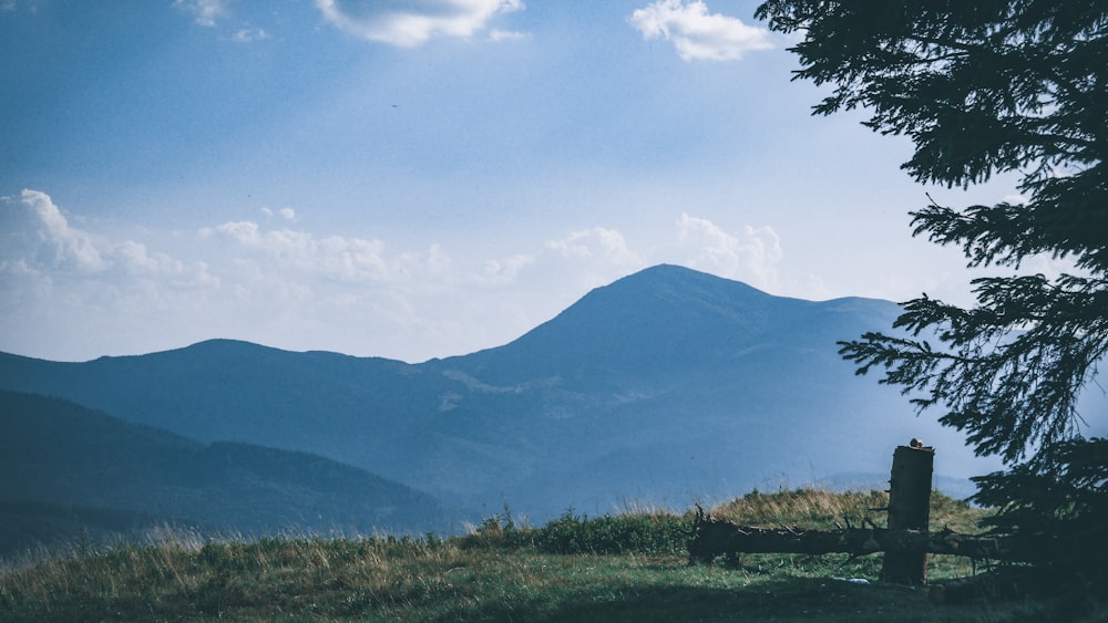 a view of a mountain range with a fence in the foreground