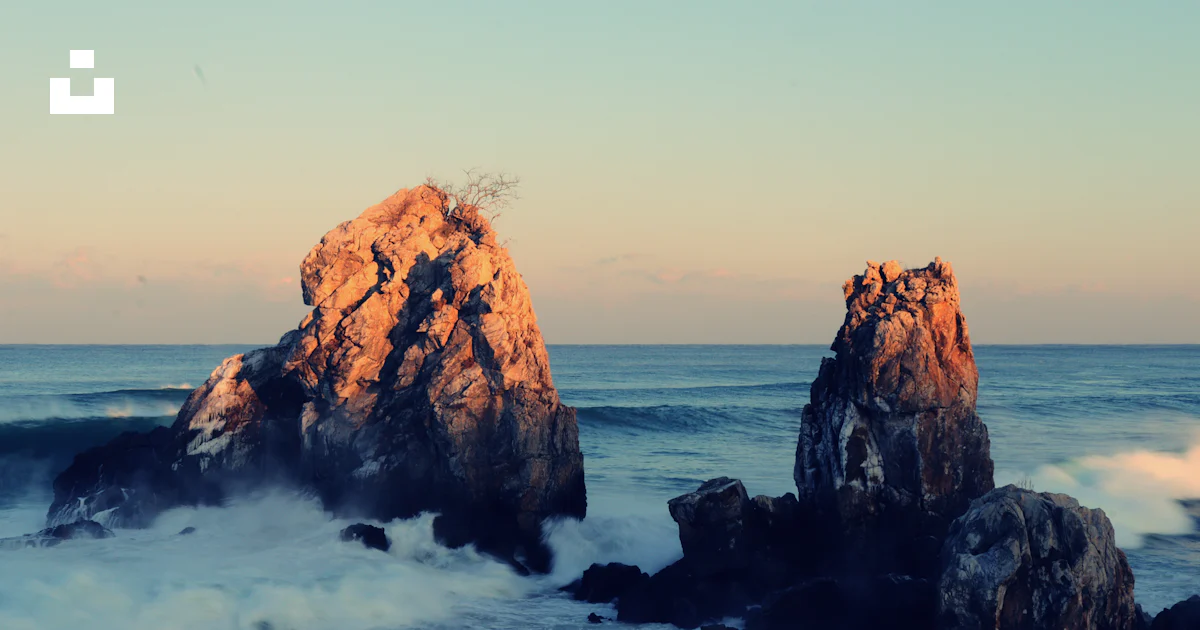 A large rock sticking out of the ocean photo – Free Waves rocks Image ...