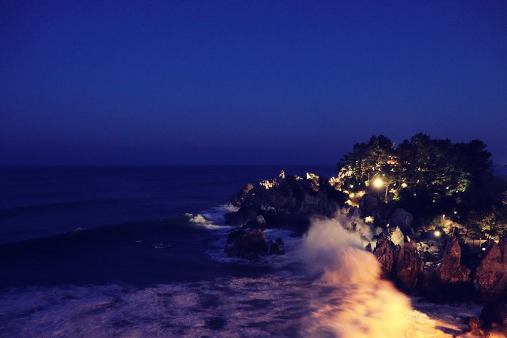 a view of the ocean at night from a cliff