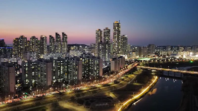 A sleek city skyline at dusk with financial graphs overlayed.
