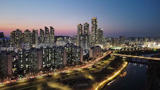 A cityscape at dusk with digital data streams overlaying the skyline.