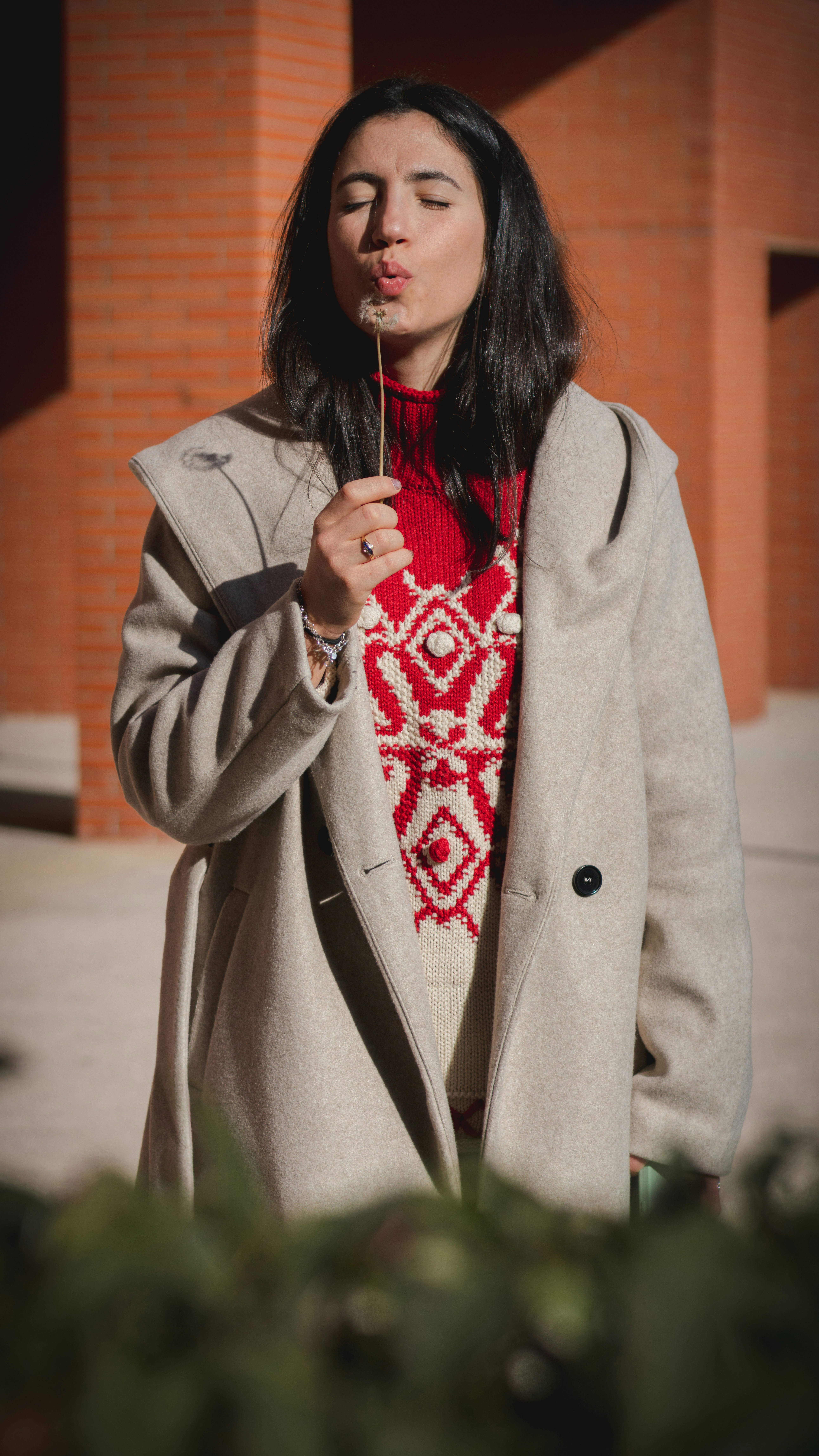 A woman standing in front of a brick building photo – Free Diente de ...