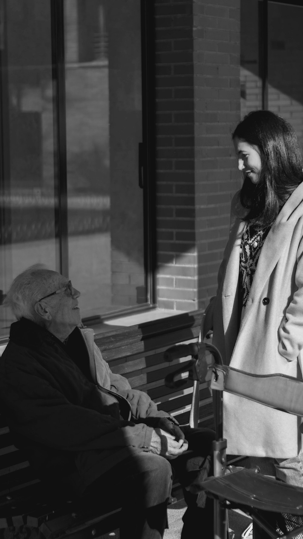 a man sitting on a bench next to a woman