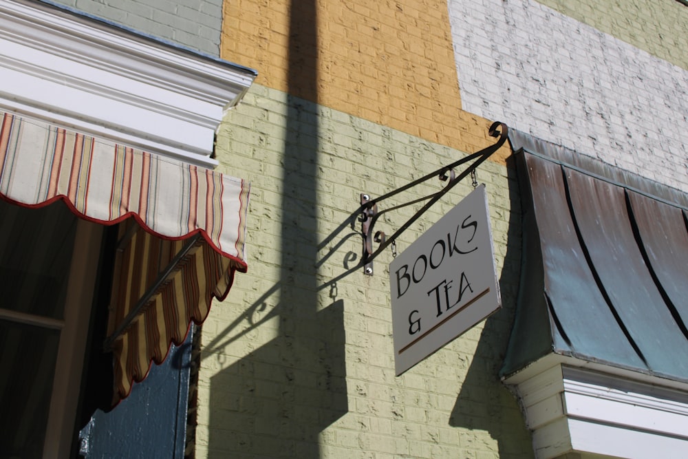 a sign hanging from the side of a building