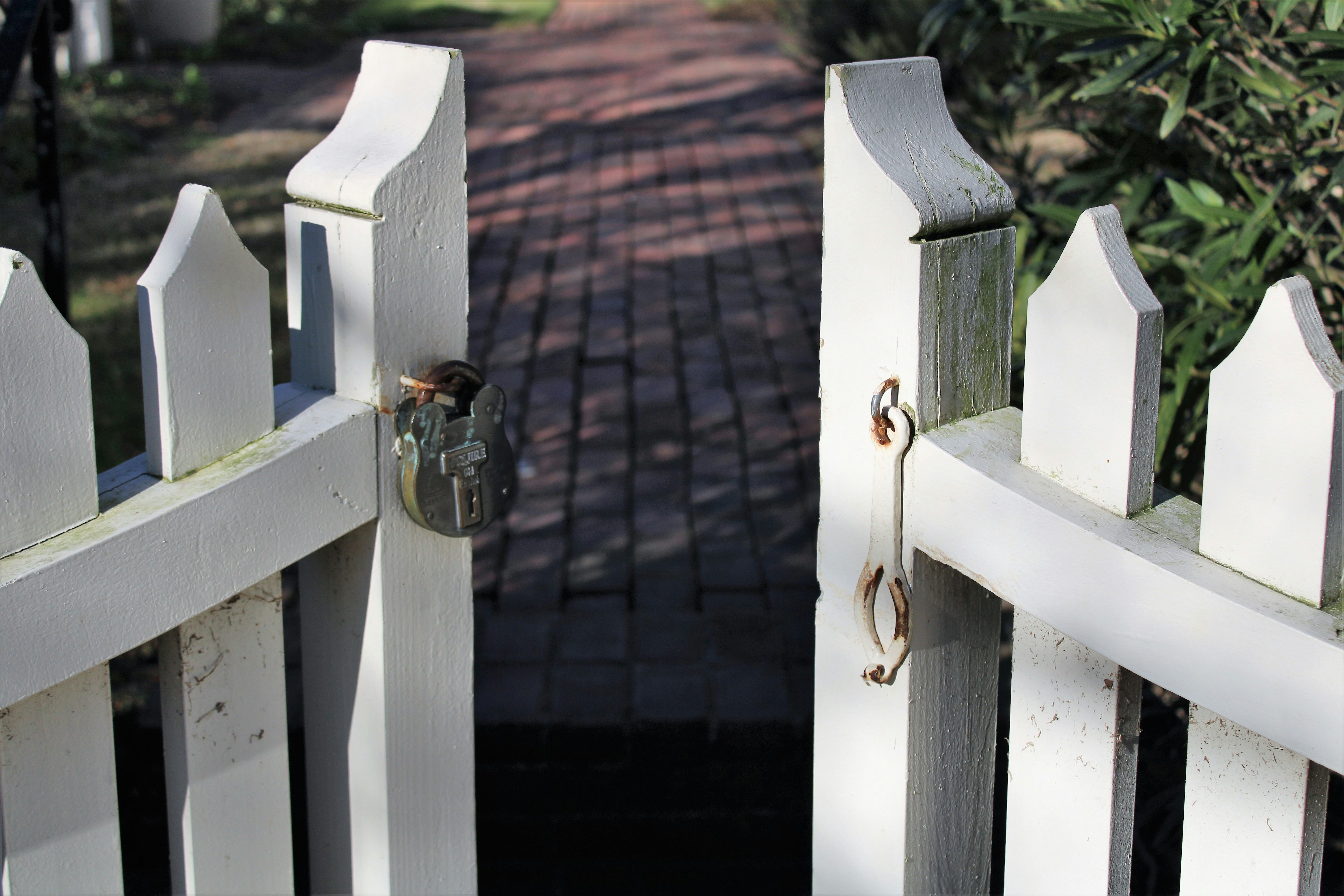 a close up of a white fence with a bird on it