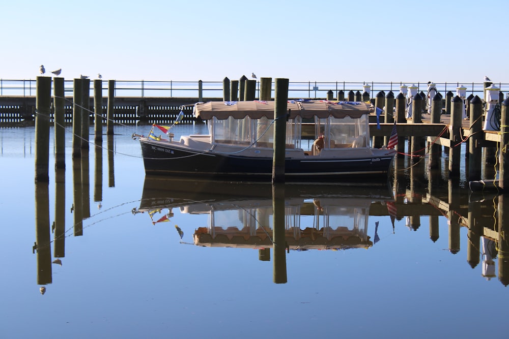 a boat is docked at a pier on a clear day