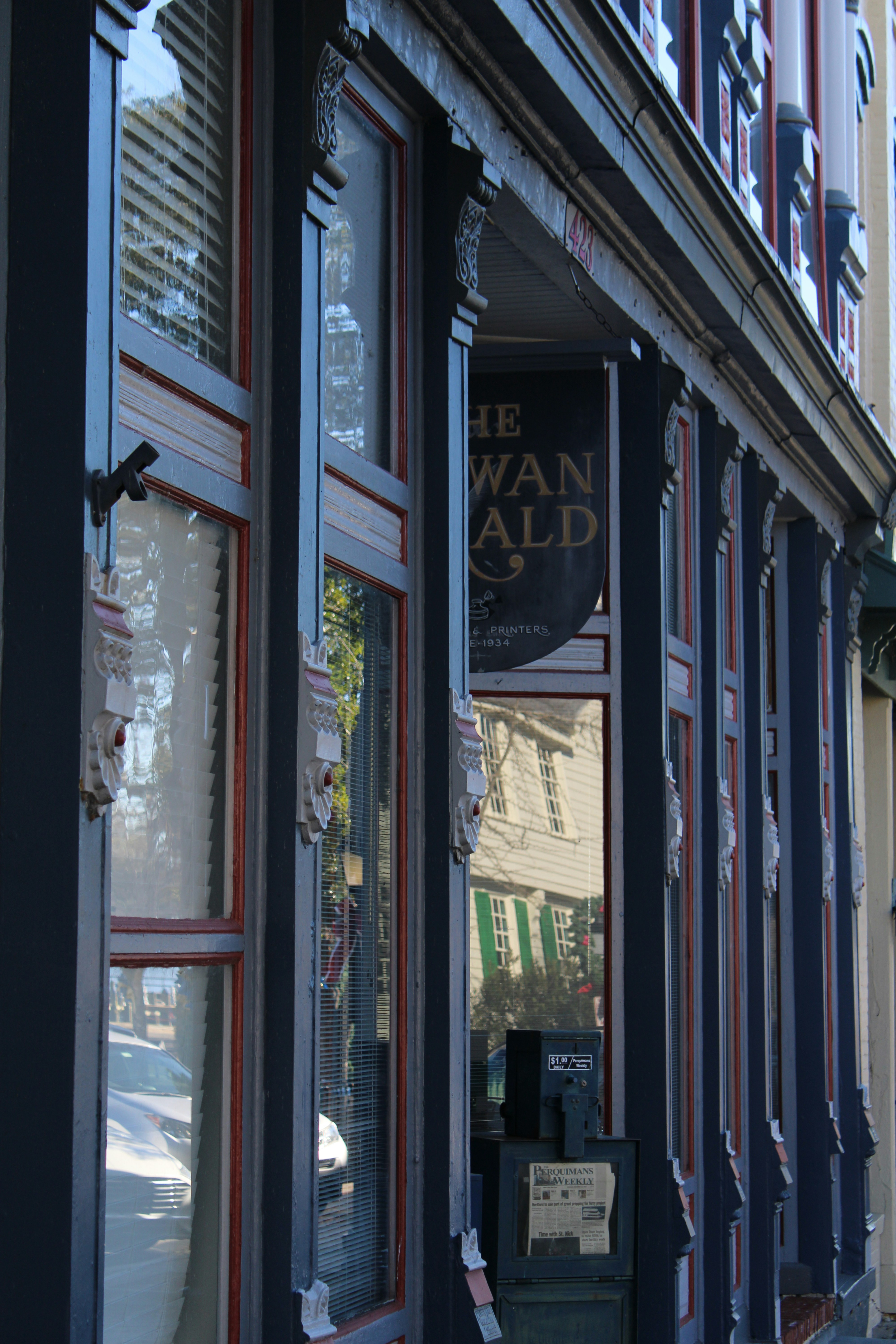 a store front with a clock on the outside of it