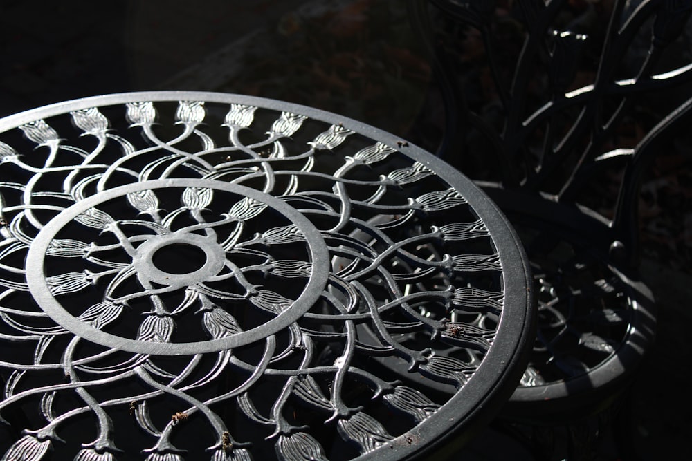 a close up of a metal table with a circular design on it