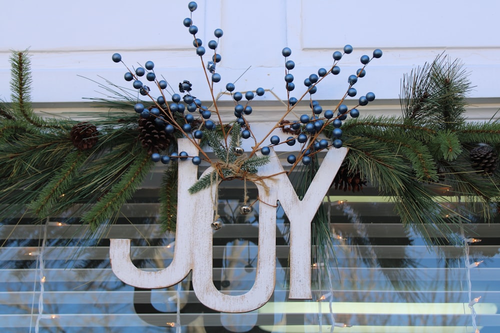 a wooden joy sign hanging from a window
