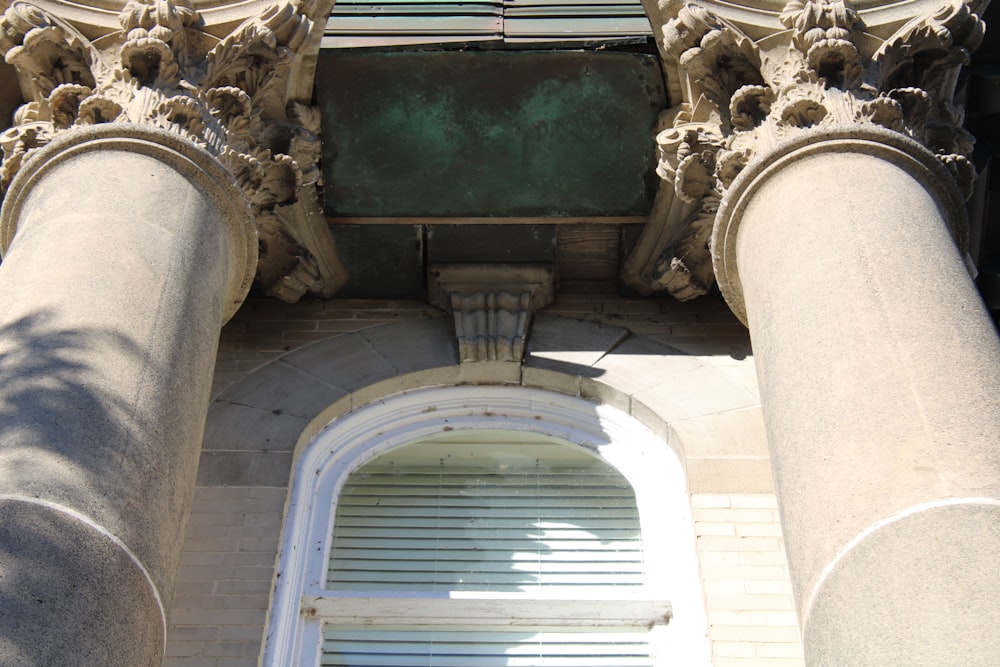 a tall building with columns and a window