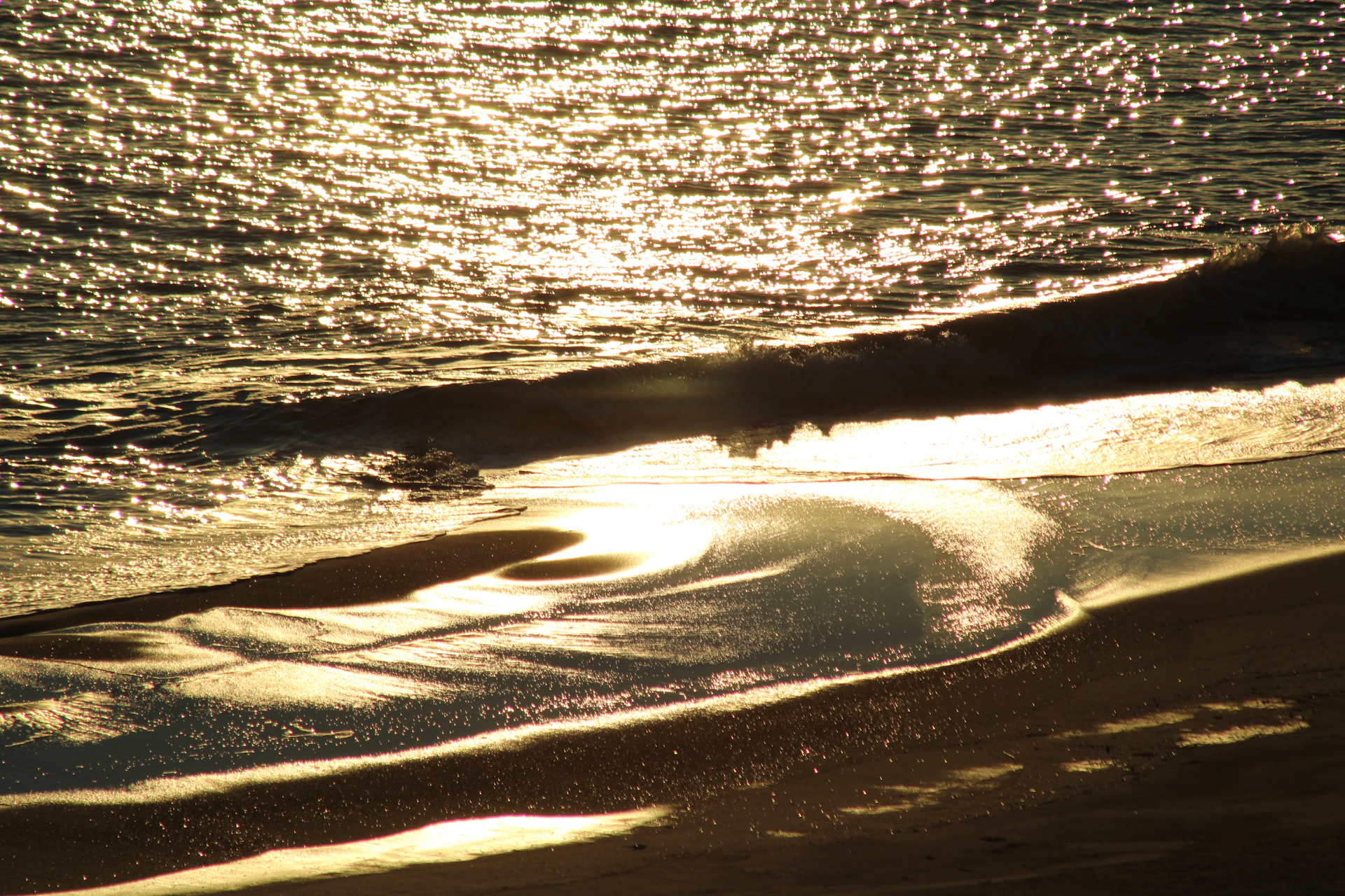 the sun shines on the water and the beach