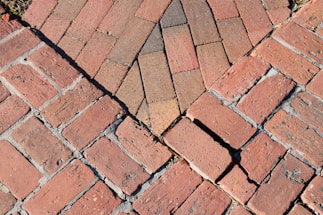 a close up of a red brick sidewalk