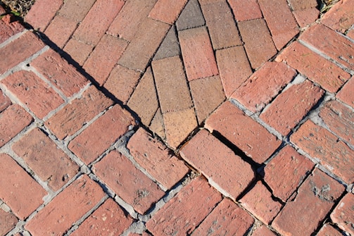 a close up of a red brick sidewalk