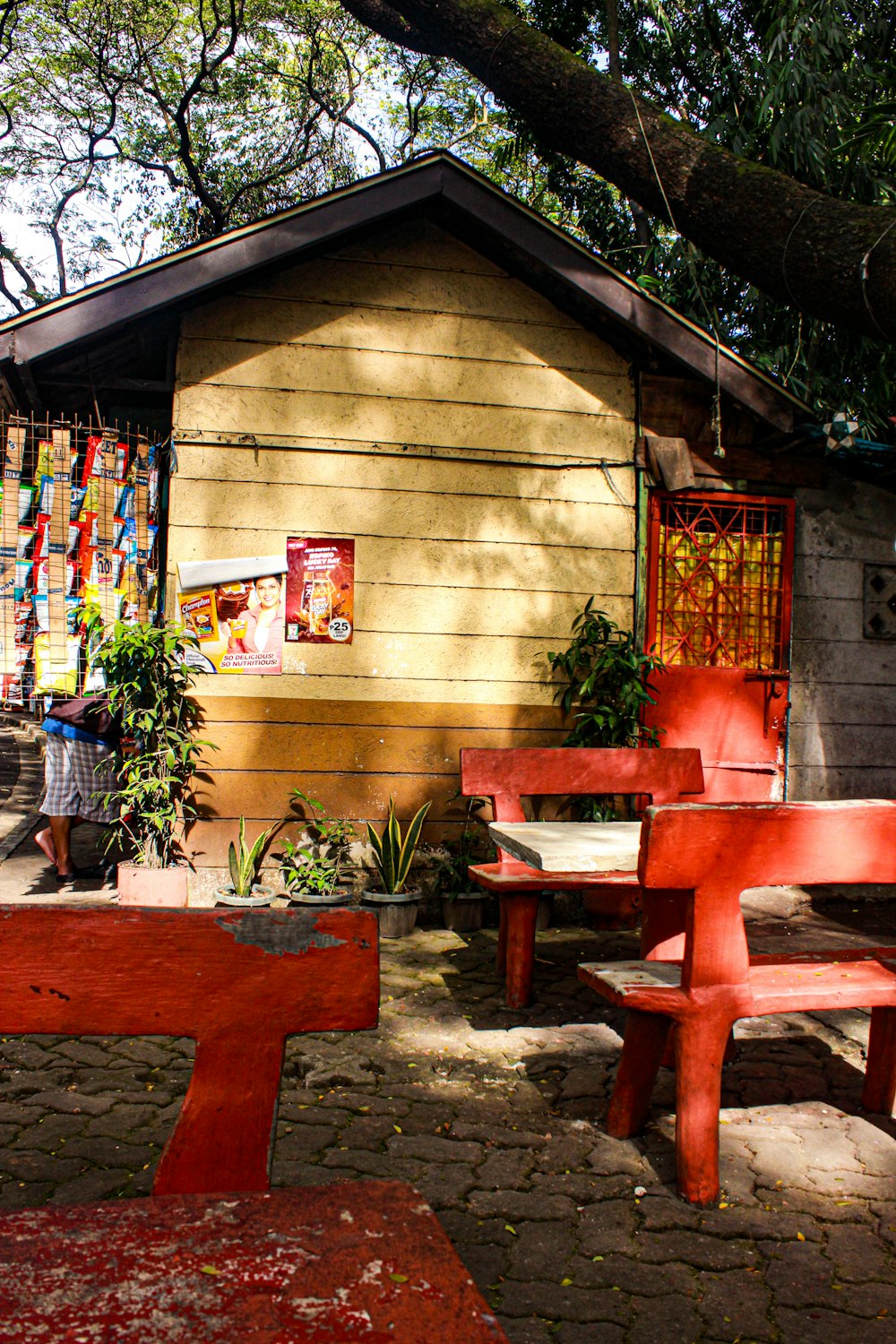 a couple of red benches sitting in front of a building