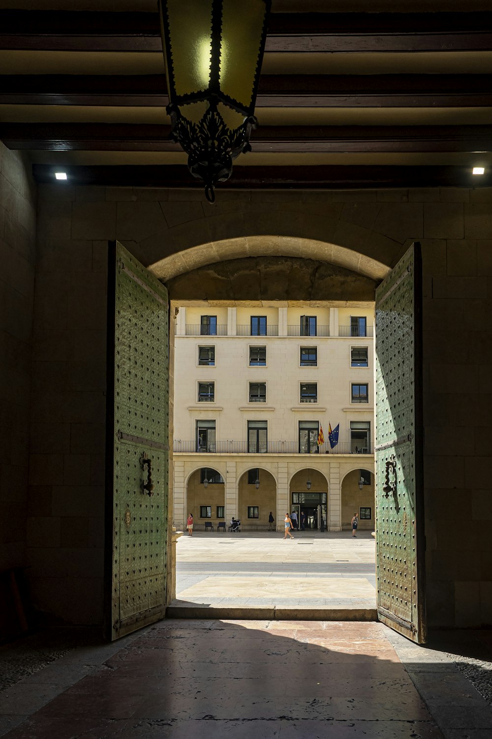 an open door leading to a building with a clock on it