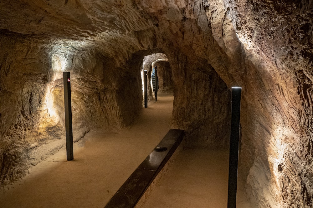 a long narrow tunnel with a bench in the middle of it