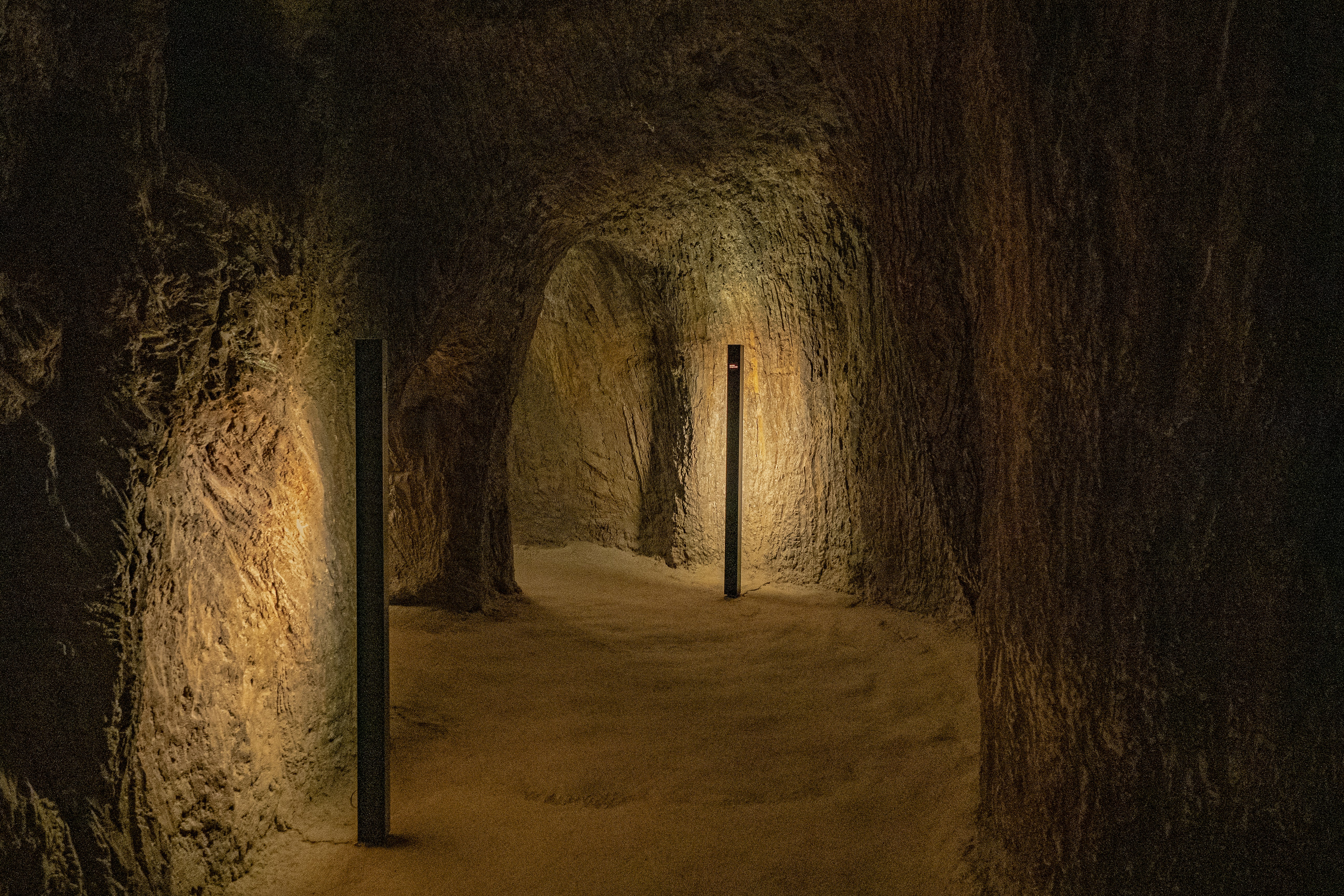 a dimly lit tunnel with a light at the end