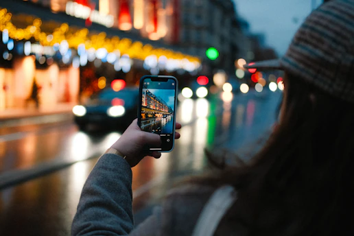 A striking mobile-shot portrait capturing a candid moment on a bustling city street at dusk.