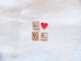 scrabble tiles spelling love and a red heart