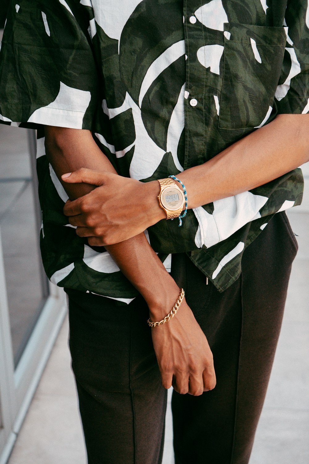 a person wearing a watch and a camo shirt