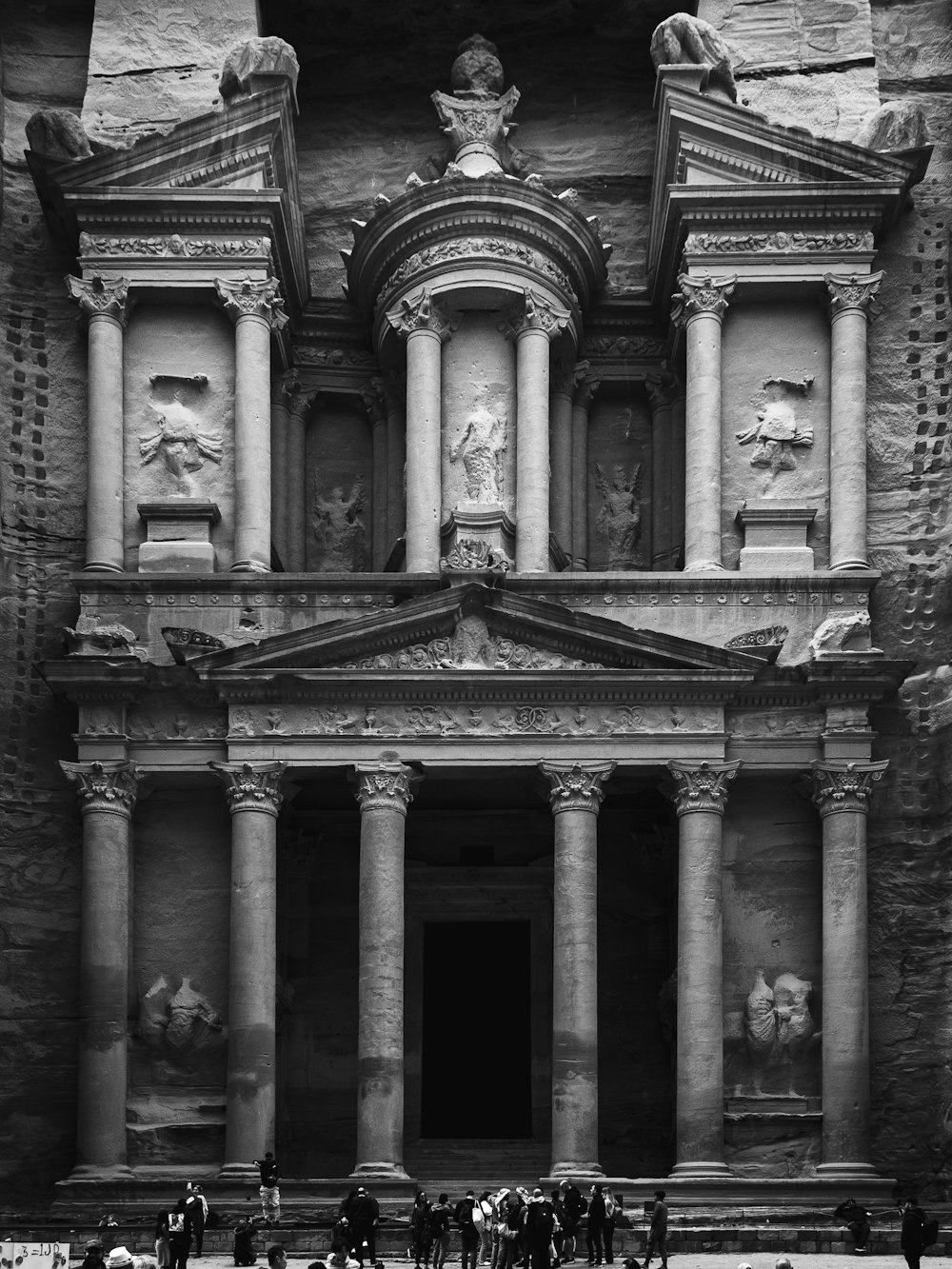 a black and white photo of people standing in front of a building