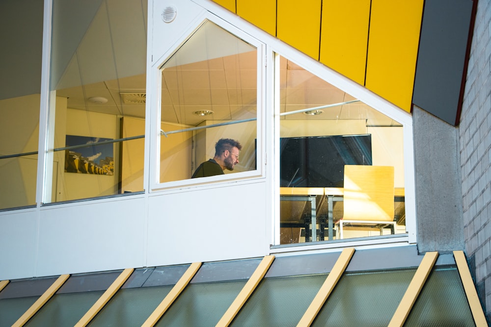 a man is looking out of a window