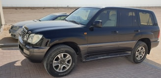 a black suv parked in a parking lot