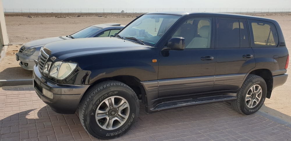 a black suv parked in a parking lot