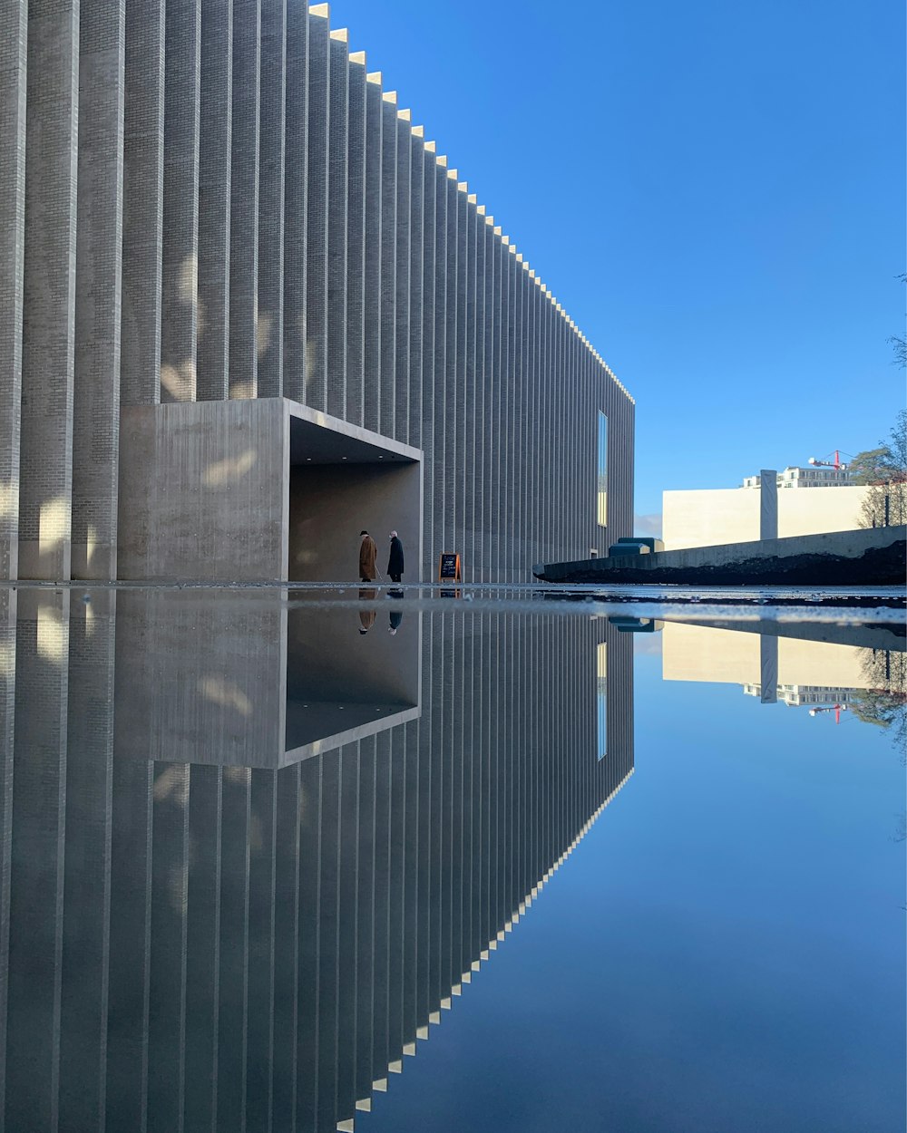 a reflection of a building in a body of water