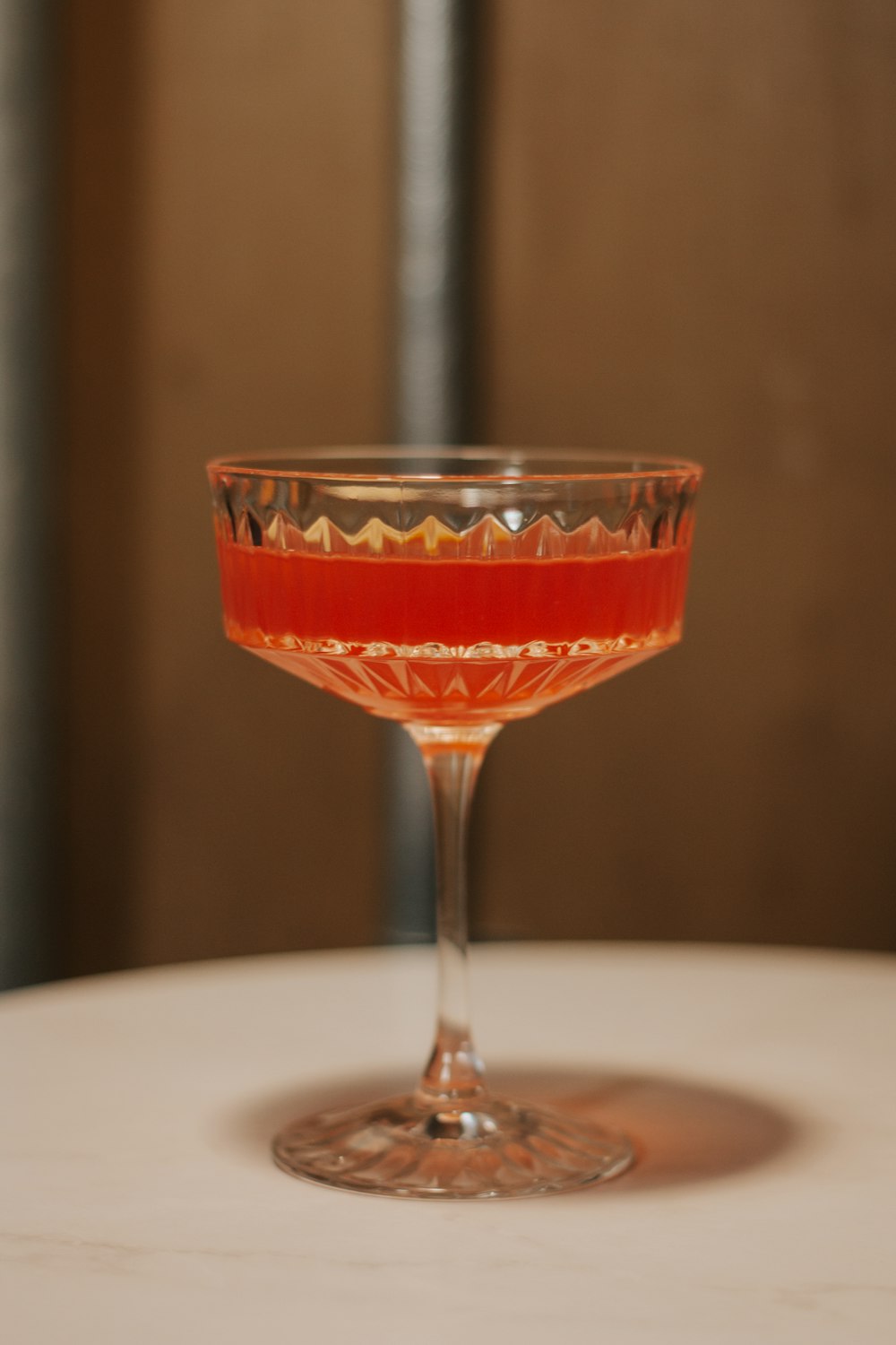 a wine glass sitting on top of a table