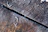 Close-up of textured wood-plastic composite decking with frost on the surface.