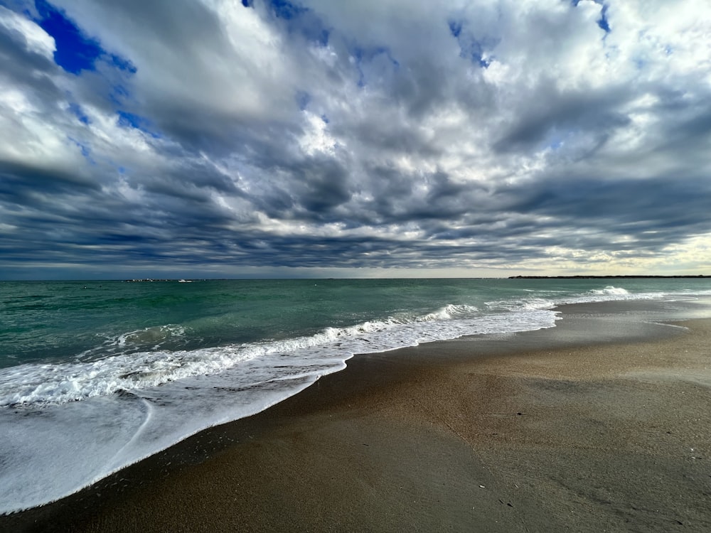 a beach with waves coming in to the shore