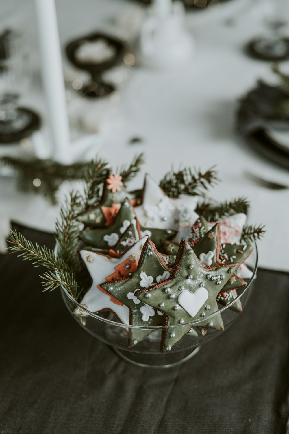 a glass bowl filled with cookies on top of a table