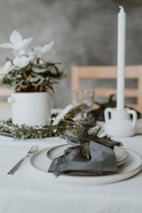 Minimalist wedding table setting with deep green and silver accents