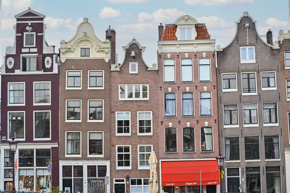 a row of buildings with a red truck parked in front of them