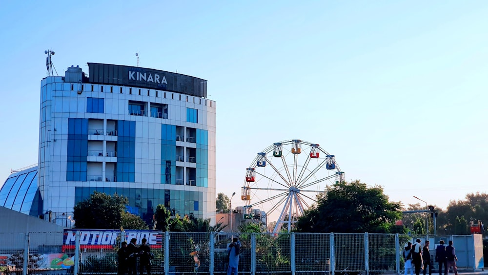 a ferris wheel in front of a tall building
